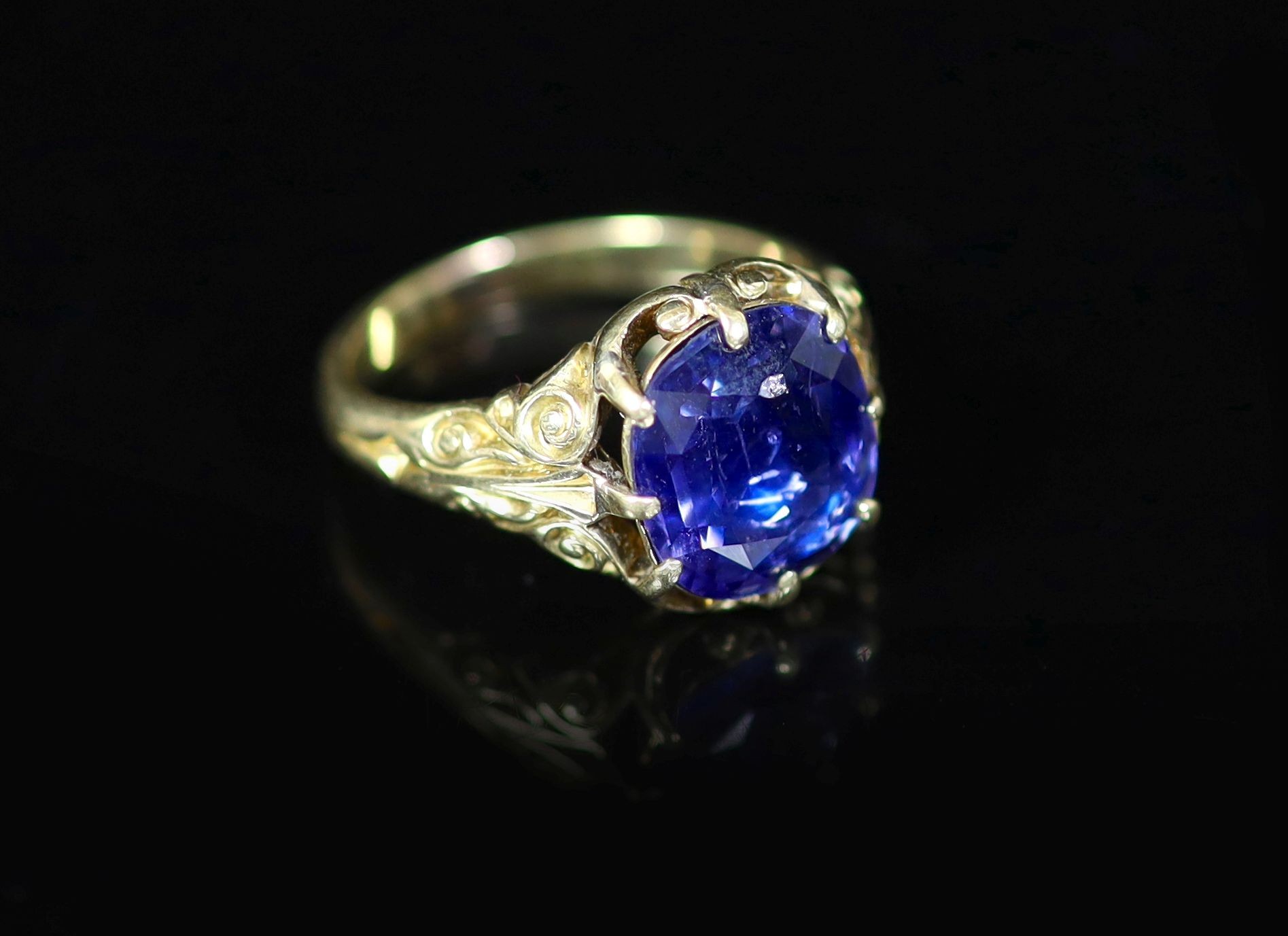 An 18ct gold and single stone claw set sapphire ring